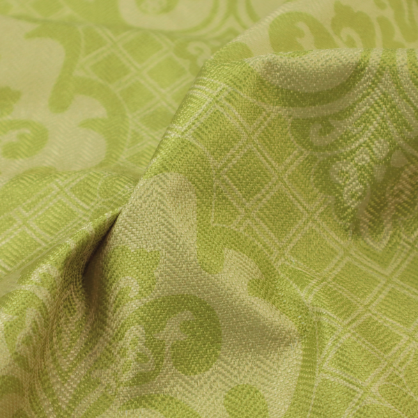 A lime green damask pattern on a textured fabric. The design features large, ornate floral medallions with stylized acanthus leaves, arranged in a repeating grid.