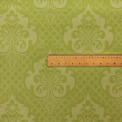 A lime green damask pattern on a textured fabric. The design features large, ornate floral medallions with stylized acanthus leaves, arranged in a repeating grid.