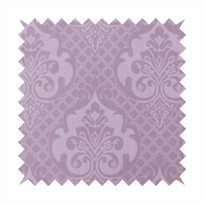 The design features large, ornate floral medallions and scrolling acanthus leaves in a light lavender shade, set against a slightly darker mauve background. A fine diagonal lattice grid fills the background between the motifs, and the material shows a clear woven texture that provides visual depth to the tonal design.