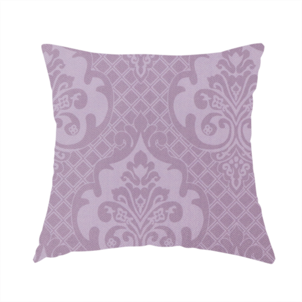 The fabric used to create this handmade cushion has a design that features large, ornate floral medallions and scrolling acanthus leaves in a light lavender shade, set against a slightly darker mauve background. A fine diagonal lattice grid fills the background between the motifs, and the material shows a clear woven texture that provides visual depth to the tonal design.