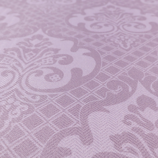 The design features large, ornate floral medallions and scrolling acanthus leaves in a light lavender shade, set against a slightly darker mauve background. A fine diagonal lattice grid fills the background between the motifs, and the material shows a clear woven texture that provides visual depth to the tonal design.