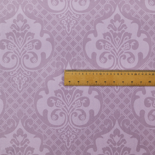 The design features large, ornate floral medallions and scrolling acanthus leaves in a light lavender shade, set against a slightly darker mauve background. A fine diagonal lattice grid fills the background between the motifs, and the material shows a clear woven texture that provides visual depth to the tonal design.