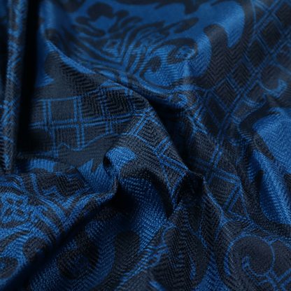 The design features large, ornate floral medallions and scrolling acanthus leaves in a bright royal blue shade, set against a deep navy background. A fine diagonal lattice grid fills the space between the motifs, and the material displays a clear woven texture that adds structural depth and a subtle sheen to the tonal blue design.