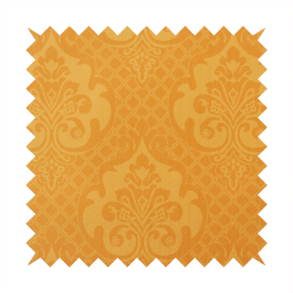 An orange damask pattern on a textured fabric. Large, ornate floral motifs and scrolling acanthus leaves are arranged in a repeating grid. These motifs are rendered in a soft peach shade against a more saturated, vibrant orange background.