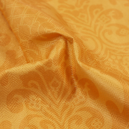 An orange damask pattern on a textured fabric. Large, ornate floral motifs and scrolling acanthus leaves are arranged in a repeating grid. These motifs are rendered in a soft peach shade against a more saturated, vibrant orange background.