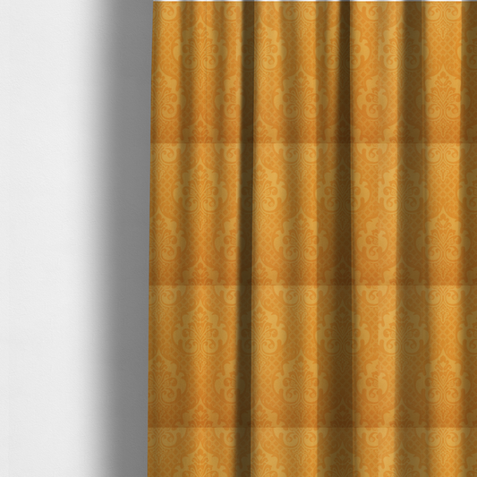 The fabric used to create these made-to-measure curtains has an orange damask pattern on a textured fabric. Large, ornate floral motifs and scrolling acanthus leaves are arranged in a repeating grid. These motifs are rendered in a soft peach shade against a more saturated, vibrant orange background.