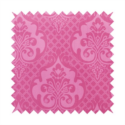 The design features large, ornate floral medallions and scrolling acanthus leaves in a lighter pink shade, set against a saturated magenta-rose background. A fine diagonal lattice grid fills the background between the motifs, and the material shows a clear woven texture that provides visual depth to the traditional design.