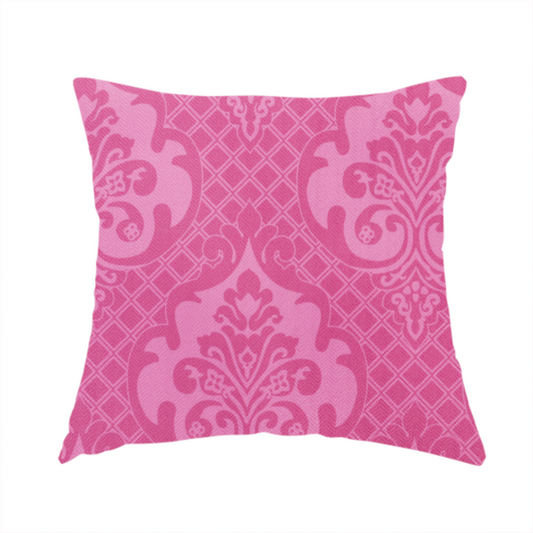The fabric used to create this handmade cushion has a design that features large, ornate floral medallions and scrolling acanthus leaves in a lighter pink shade, set against a saturated magenta-rose background. A fine diagonal lattice grid fills the background between the motifs, and the material shows a clear woven texture that provides visual depth to the traditional design.
