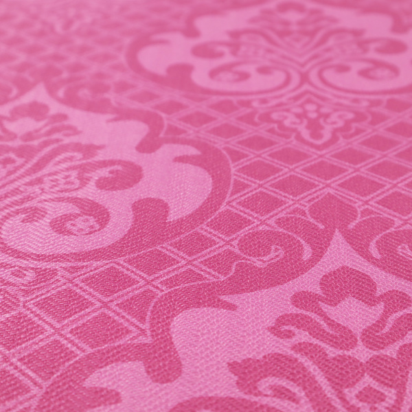 The design features large, ornate floral medallions and scrolling acanthus leaves in a lighter pink shade, set against a saturated magenta-rose background. A fine diagonal lattice grid fills the background between the motifs, and the material shows a clear woven texture that provides visual depth to the traditional design.