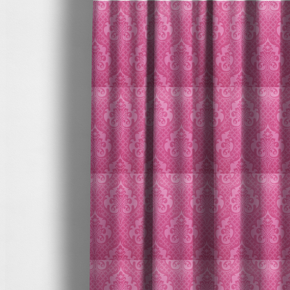 The fabric used to create these made-to-measure curtains has a design that features large, ornate floral medallions and scrolling acanthus leaves in a lighter pink shade, set against a saturated magenta-rose background. A fine diagonal lattice grid fills the background between the motifs, and the material shows a clear woven texture that provides visual depth to the traditional design.