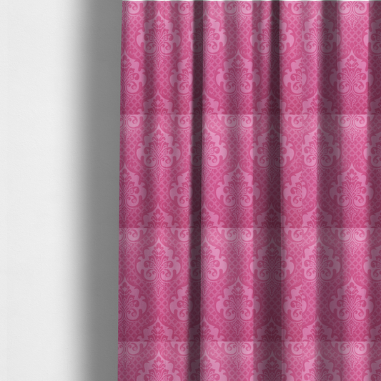 The fabric used to create these made-to-measure curtains has a design that features large, ornate floral medallions and scrolling acanthus leaves in a lighter pink shade, set against a saturated magenta-rose background. A fine diagonal lattice grid fills the background between the motifs, and the material shows a clear woven texture that provides visual depth to the traditional design.