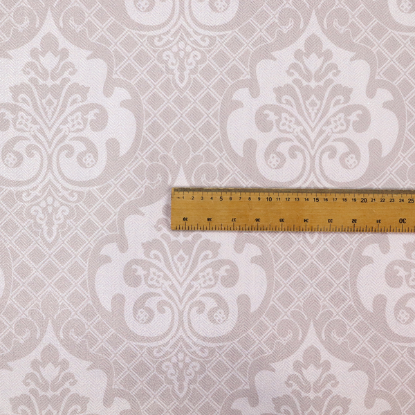 A baby pink and cream damask pattern on a textured fabric. The design features large, ornate floral medallions with stylized acanthus leaf scrolls, arranged in a structured, repeating grid.