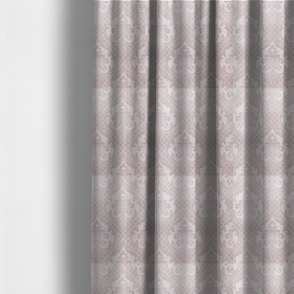 The fabric used to create these made-to-measure curtains has a baby pink and cream damask pattern on a textured fabric. The design features large, ornate floral medallions with stylized acanthus leaf scrolls, arranged in a structured, repeating grid.