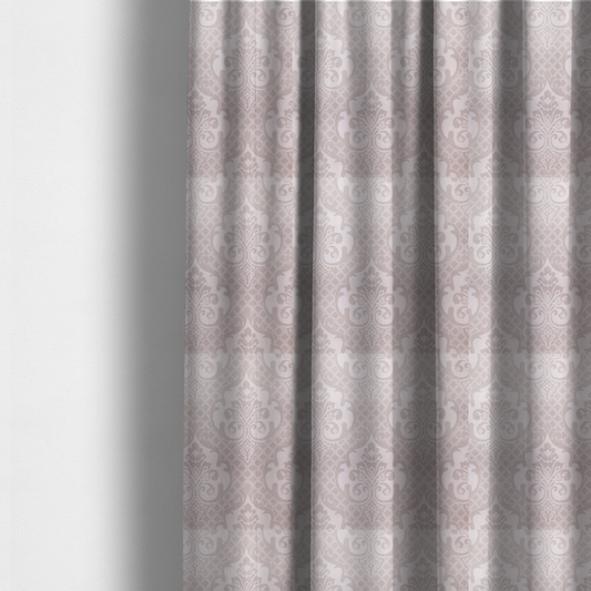 The fabric used to create these made-to-measure curtains has a baby pink and cream damask pattern on a textured fabric. The design features large, ornate floral medallions with stylized acanthus leaf scrolls, arranged in a structured, repeating grid.