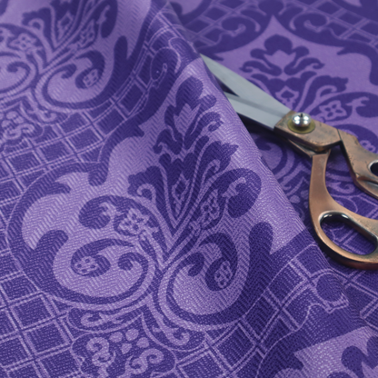 The design features large, ornate floral medallions and scrolling acanthus leaves in a lighter violet shade, set against a deep, saturated purple background. A fine diagonal lattice grid fills the background between the motifs, and the material displays a clear woven texture that adds structural depth and a sophisticated sheen to the tonal design.