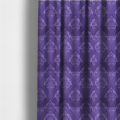 The fabric used to create these made-to-measure curtains has a design that features large, ornate floral medallions and scrolling acanthus leaves in a lighter violet shade, set against a deep, saturated purple background. A fine diagonal lattice grid fills the background between the motifs, and the material displays a clear woven texture that adds structural depth and a sophisticated sheen to the tonal design.