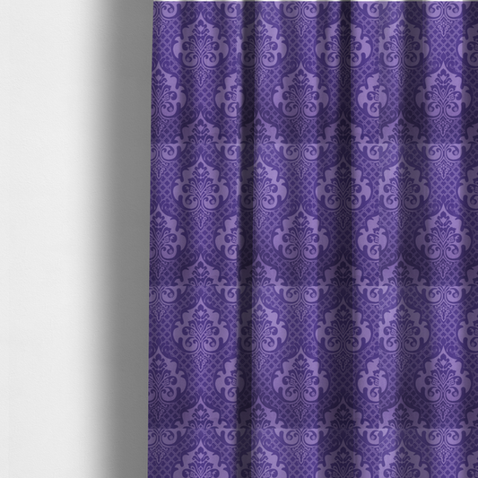 The fabric used to create these made-to-measure curtains has a design that features large, ornate floral medallions and scrolling acanthus leaves in a lighter violet shade, set against a deep, saturated purple background. A fine diagonal lattice grid fills the background between the motifs, and the material displays a clear woven texture that adds structural depth and a sophisticated sheen to the tonal design.