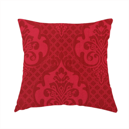 The fabric used to create these handmade cushions has a design that features large, ornate floral medallions and scrolling acanthus leaves in a slightly lighter shade of red, creating a tonal, high-contrast effect. A fine diagonal lattice grid fills the background between the motifs, and the material shows a clear woven texture that adds depth and a traditional feel to the design.