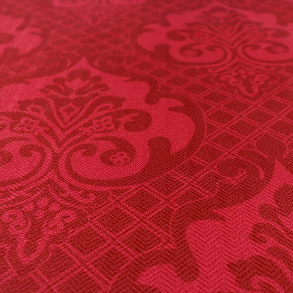 The design features large, ornate floral medallions and scrolling acanthus leaves in a slightly lighter shade of red, creating a tonal, high-contrast effect. A fine diagonal lattice grid fills the background between the motifs, and the material shows a clear woven texture that adds depth and a traditional feel to the design.