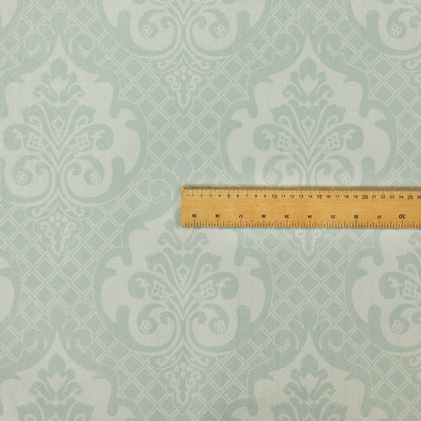 The design showcases large, ornate floral medallions and scrolling acanthus leaves in a light silver shade, set against a slightly darker grey-white background. A fine diagonal lattice grid creates a diamond pattern in the negative space between the motifs, and the material displays a clear woven texture that adds a sophisticated, metallic-like shimmer to the pattern.