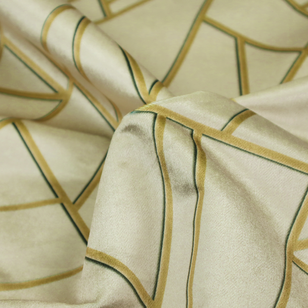 A close-up of a luxurious fabric featuring a geometric, fractured glass pattern. The design consists of irregular, sharp-angled polygons in a pale sage green or muted seafoam hue. These shapes are separated by thick, shimmering gold metallic lines that appear slightly recessed or embossed, creating a high-contrast, mosaic-like effect.