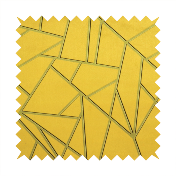 A close-up of a luxurious mustard yellow fabric featuring a bold geometric, fractured pattern. The design is composed of sharp, irregular polygons separated by embossed tone-on-tone lines in a slightly darker, olive-tinted gold.