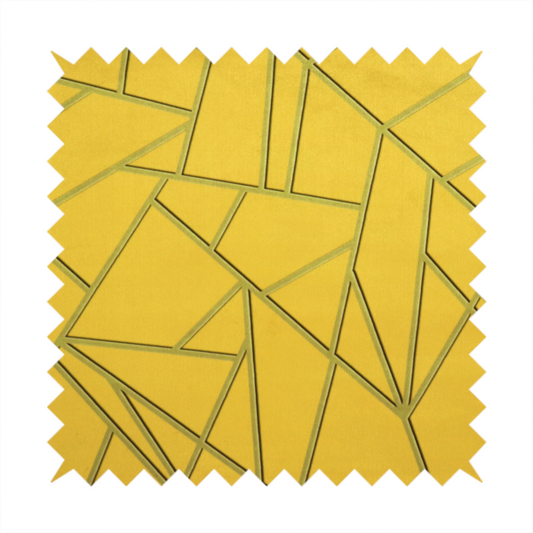 A close-up of a luxurious mustard yellow fabric featuring a bold geometric, fractured pattern. The design is composed of sharp, irregular polygons separated by embossed tone-on-tone lines in a slightly darker, olive-tinted gold.