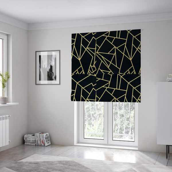 The fabric used to create these Roman blinds is  a high-contrast black and gold fabric featuring a fractured, geometric mosaic design. The deep, matte black background is intersected by a network of sharp, metallic gold lines that form irregular, angular polygons. The pattern resembles a web of shimmering gold veins or a stylized shattered-glass effect, giving the textile a luxurious, Art Deco-inspired aesthetic.