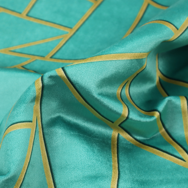 A close-up of a luxurious teal or bright turquoise fabric featuring a fractured, geometric mosaic pattern. The vibrant, plush background is divided by a network of shimmering metallic gold lines that form sharp, irregular polygons. The design creates a striking shattered-glass or "cracked ice" effect, blending a high-energy jewel tone with sophisticated, Art Deco-inspired gold linework for a modern, architectural look.