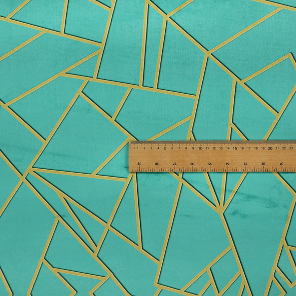 A close-up of a luxurious teal or bright turquoise fabric featuring a fractured, geometric mosaic pattern. The vibrant, plush background is divided by a network of shimmering metallic gold lines that form sharp, irregular polygons. The design creates a striking shattered-glass or "cracked ice" effect, blending a high-energy jewel tone with sophisticated, Art Deco-inspired gold linework for a modern, architectural look.