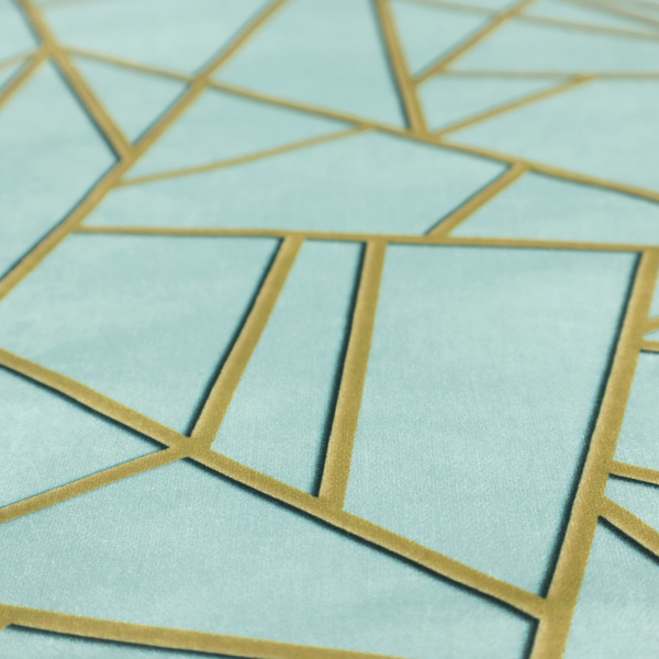 A close-up of a luxurious light aqua or pale sky blue fabric featuring a fractured, geometric mosaic pattern. The soft, matte background is segmented by a network of embossed metallic gold lines that create sharp, irregular polygons. This "cracked ice" or shattered-glass effect pairs a serene, cool-toned pastel with warm, shimmering gold linework for a sophisticated and modern Art Deco-inspired look.