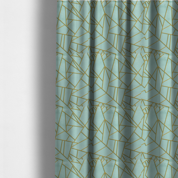 The fabric used to create these made-to-measure curtains is a luxurious light aqua or pale sky blue fabric featuring a fractured, geometric mosaic pattern. The soft, matte background is segmented by a network of embossed metallic gold lines that create sharp, irregular polygons. This "cracked ice" or shattered-glass effect pairs a serene, cool-toned pastel with warm, shimmering gold linework for a sophisticated and modern Art Deco-inspired look.