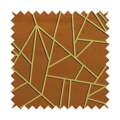 A close-up of a luxurious brown or rust-coloured fabric featuring a fractured, geometric mosaic pattern. The warm, matte background is divided by a network of recessed gold metallic lines that form sharp, irregular polygons. This "cracked ice" or shattered-glass effect creates a bold, architectural look, blending the deep, earthy tones of the textile with shimmering, Art Deco-inspired accents.