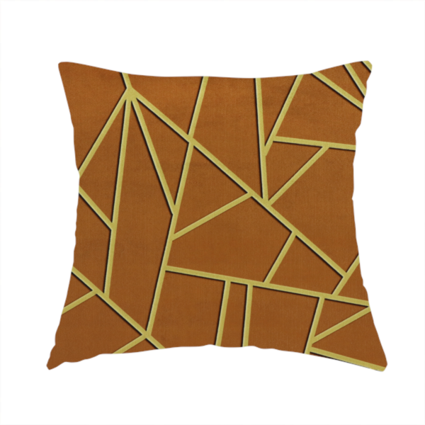 The fabric used to create this handmade cushion is a luxurious brown or rust-coloured fabric featuring a fractured, geometric mosaic pattern. The warm, matte background is divided by a network of recessed gold metallic lines that form sharp, irregular polygons. This "cracked ice" or shattered-glass effect creates a bold, architectural look, blending the deep, earthy tones of the textile with shimmering, Art Deco-inspired accents.