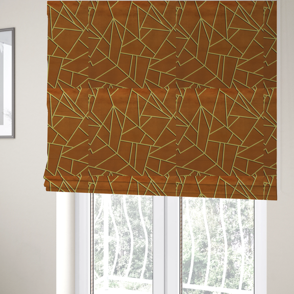The fabric used to create these Roman blinds is a luxurious brown or rust-coloured fabric featuring a fractured, geometric mosaic pattern. The warm, matte background is divided by a network of recessed gold metallic lines that form sharp, irregular polygons. This "cracked ice" or shattered-glass effect creates a bold, architectural look, blending the deep, earthy tones of the textile with shimmering, Art Deco-inspired accents.