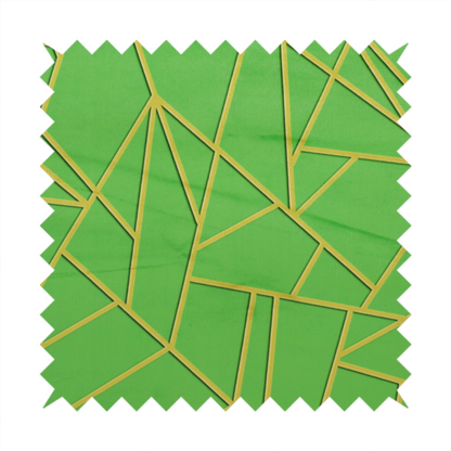 A close-up of a vibrant bright green fabric featuring a fractured, geometric mosaic pattern. The lively, matte background is segmented by a network of recessed metallic gold lines that form sharp, irregular polygons. This "cracked ice" or shattered-glass effect creates a bold, modern look, combining a lush, verdant base with shimmering, Art Deco-inspired accents.