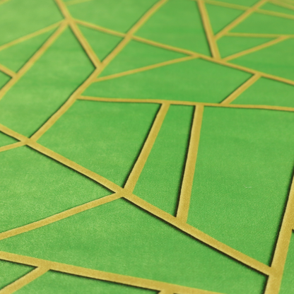 A close-up of a vibrant bright green fabric featuring a fractured, geometric mosaic pattern. The lively, matte background is segmented by a network of recessed metallic gold lines that form sharp, irregular polygons. This "cracked ice" or shattered-glass effect creates a bold, modern look, combining a lush, verdant base with shimmering, Art Deco-inspired accents.