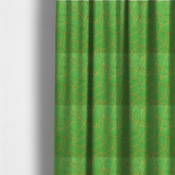 The fabric used to create these made-to-measure curtains is a vibrant bright green fabric featuring a fractured, geometric mosaic pattern. The lively, matte background is segmented by a network of recessed metallic gold lines that form sharp, irregular polygons. This "cracked ice" or shattered-glass effect creates a bold, modern look, combining a lush, verdant base with shimmering, Art Deco-inspired accents.