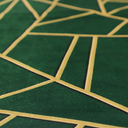 A close-up of a luxurious forest green fabric featuring a fractured, geometric mosaic pattern. The dark, velvety background is segmented by a network of recessed metallic gold lines that form sharp, irregular polygons. This "shattered-glass" effect pairs a sophisticated, deep-toned base with shimmering, Art Deco-inspired gold linework for a dramatic and architectural look.