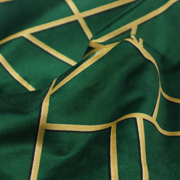 A close-up of a luxurious forest green fabric featuring a fractured, geometric mosaic pattern. The dark, velvety background is segmented by a network of recessed metallic gold lines that form sharp, irregular polygons. This "shattered-glass" effect pairs a sophisticated, deep-toned base with shimmering, Art Deco-inspired gold linework for a dramatic and architectural look.