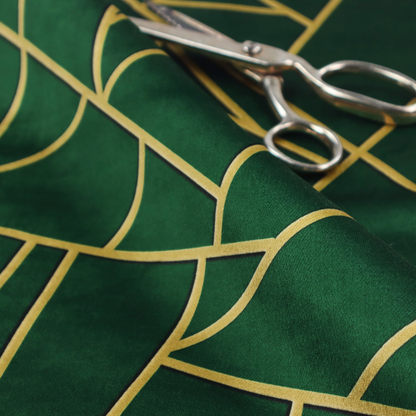 A close-up of a luxurious forest green fabric featuring a fractured, geometric mosaic pattern. The dark, velvety background is segmented by a network of recessed metallic gold lines that form sharp, irregular polygons. This "shattered-glass" effect pairs a sophisticated, deep-toned base with shimmering, Art Deco-inspired gold linework for a dramatic and architectural look.