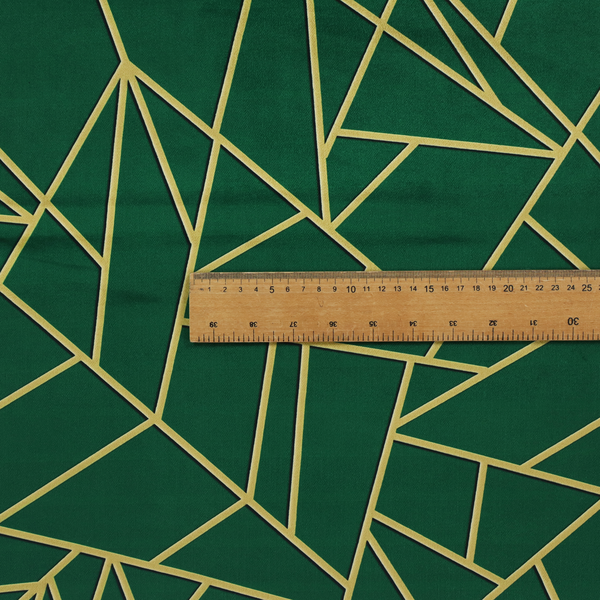 A close-up of a luxurious forest green fabric featuring a fractured, geometric mosaic pattern. The dark, velvety background is segmented by a network of recessed metallic gold lines that form sharp, irregular polygons. This "shattered-glass" effect pairs a sophisticated, deep-toned base with shimmering, Art Deco-inspired gold linework for a dramatic and architectural look.