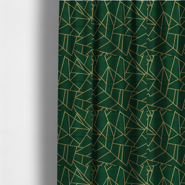 The fabric used to create these made-to-measure curtains is a luxurious forest green fabric featuring a fractured, geometric mosaic pattern. The dark, velvety background is segmented by a network of recessed metallic gold lines that form sharp, irregular polygons. This "shattered-glass" effect pairs a sophisticated, deep-toned base with shimmering, Art Deco-inspired gold linework for a dramatic and architectural look.