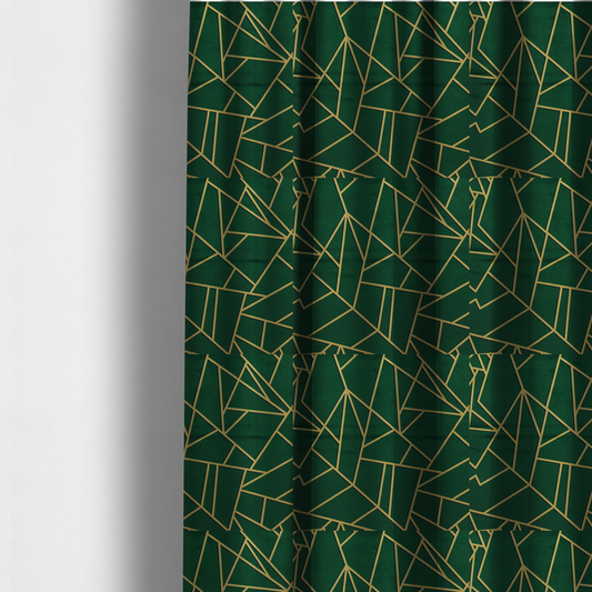 The fabric used to create these made-to-measure curtains is a luxurious forest green fabric featuring a fractured, geometric mosaic pattern. The dark, velvety background is segmented by a network of recessed metallic gold lines that form sharp, irregular polygons. This "shattered-glass" effect pairs a sophisticated, deep-toned base with shimmering, Art Deco-inspired gold linework for a dramatic and architectural look.