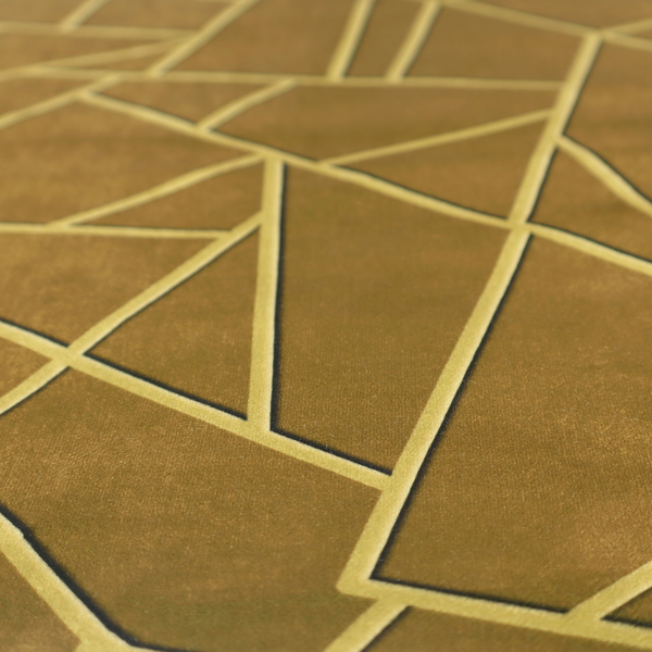 A close-up of a luxurious olive gold or antique brass-coloured fabric featuring a fractured, geometric mosaic pattern. The rich, matte background is segmented by a network of recessed tone-on-tone lines in a slightly lighter, shimmering shade. This "cracked ice" or shattered-glass effect creates a subtle, sophisticated 3D texture, blending mid-century modern influence with contemporary Art Deco elegance.