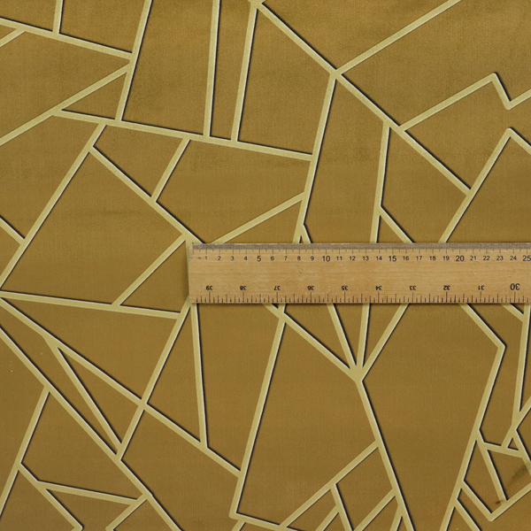 A close-up of a luxurious olive gold or antique brass-coloured fabric featuring a fractured, geometric mosaic pattern. The rich, matte background is segmented by a network of recessed tone-on-tone lines in a slightly lighter, shimmering shade. This "cracked ice" or shattered-glass effect creates a subtle, sophisticated 3D texture, blending mid-century modern influence with contemporary Art Deco elegance.