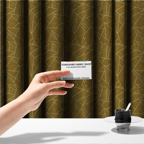 The fabric used to create these made-to-measure curtains is a luxurious olive gold or antique brass-coloured fabric featuring a fractured, geometric mosaic pattern. The rich, matte background is segmented by a network of recessed tone-on-tone lines in a slightly lighter, shimmering shade. This "cracked ice" or shattered-glass effect creates a subtle, sophisticated 3D texture, blending mid-century modern influence with contemporary Art Deco elegance.