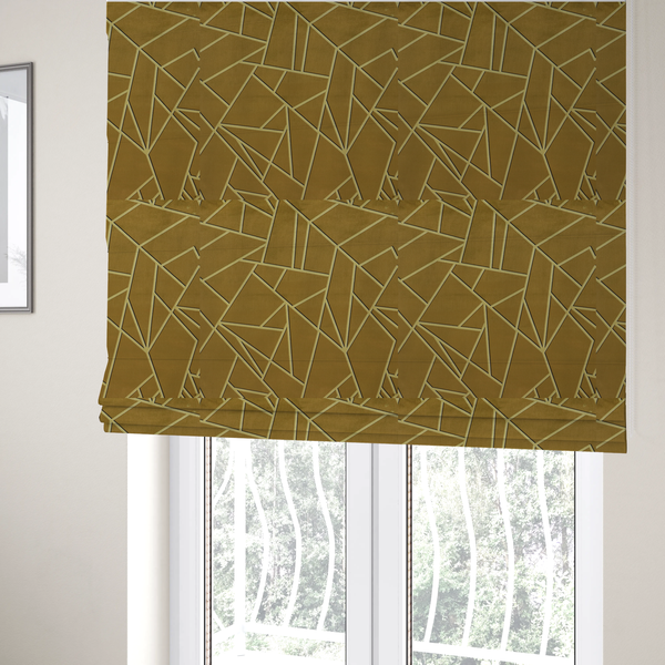 The fabric used to create these Roman blinds is a luxurious olive gold or antique brass-coloured fabric featuring a fractured, geometric mosaic pattern. The rich, matte background is segmented by a network of recessed tone-on-tone lines in a slightly lighter, shimmering shade. This "cracked ice" or shattered-glass effect creates a subtle, sophisticated 3D texture, blending mid-century modern influence with contemporary Art Deco elegance.