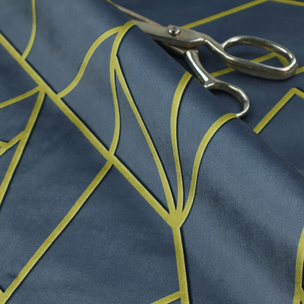 A close-up of a luxurious slate grey fabric featuring a fractured, geometric mosaic pattern. The deep, matte background is segmented by a network of recessed metallic gold lines that form sharp, irregular polygons. This "shattered-glass" effect creates a striking visual contrast, blending the cool, dark tones of the textile with shimmering, Art Deco-inspired accents for a modern, high-end look.