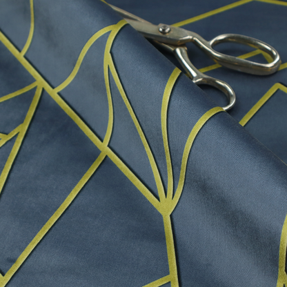 A close-up of a luxurious slate grey fabric featuring a fractured, geometric mosaic pattern. The deep, matte background is segmented by a network of recessed metallic gold lines that form sharp, irregular polygons. This "shattered-glass" effect creates a striking visual contrast, blending the cool, dark tones of the textile with shimmering, Art Deco-inspired accents for a modern, high-end look.